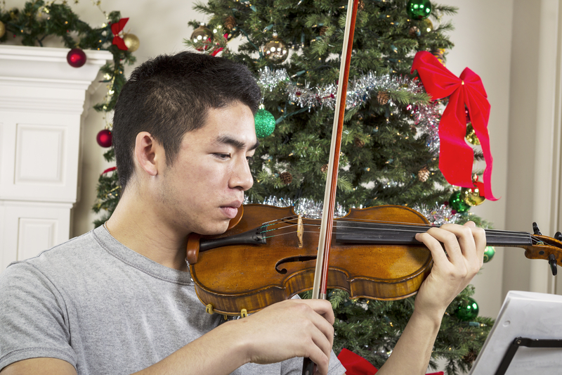Young Adult Man Playing Music During the Holidays